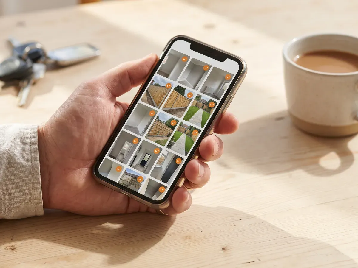 Somebody choosing photographs of their own work on a phone to send over.