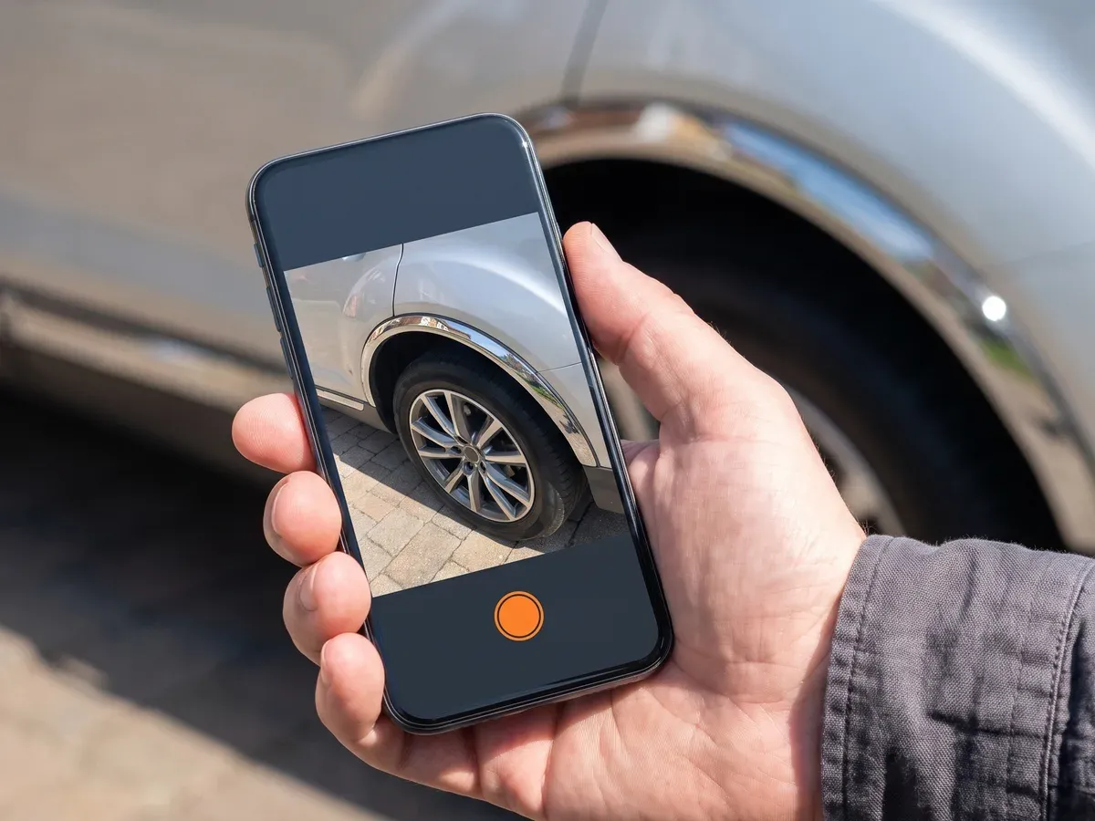 Somebody photographing a fault on their car to send to the garage.